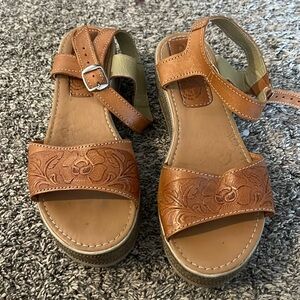 Tooled leather platform wedges, made in Mexico.